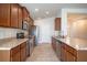 Modern kitchen with stainless steel appliances and wood cabinets at 1274 Zambrana Ct, Winter Haven, FL 33884