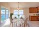 Bright dining area with a round glass table and white chairs at 1274 Zambrana Ct, Winter Haven, FL 33884