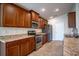 Modern kitchen with stainless steel appliances and wood cabinets at 1274 Zambrana Ct, Winter Haven, FL 33884