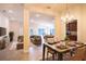 Open concept dining area with a large table and modern chandelier at 1274 Zambrana Ct, Winter Haven, FL 33884