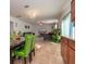 Dining area with green chairs and view of living room at 940 Waterville Dr, Auburndale, FL 33823
