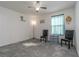 Simple bedroom with two chairs, a dresser, and a window at 940 Waterville Dr, Auburndale, FL 33823