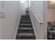 Gray carpeted staircase leading to the upper level at 940 Waterville Dr, Auburndale, FL 33823