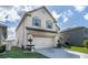 Two-story house with a front yard, driveway, and landscaping at 940 Waterville Dr, Auburndale, FL 33823