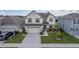 Two-story house with a two-car garage and manicured lawn at 940 Waterville Dr, Auburndale, FL 33823