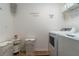 Convenient laundry room with washer, dryer, and shelving at 940 Waterville Dr, Auburndale, FL 33823