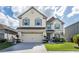 Two-story house with a large yard and two-car garage at 940 Waterville Dr, Auburndale, FL 33823