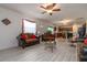 Open living room with kitchen view, comfortable seating, and hardwood floors at 940 Waterville Dr, Auburndale, FL 33823