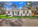 Newly renovated home with white exterior, landscaping and porch at 1211 Hollywood Ln, Lakeland, FL 33809