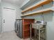 Laundry room with washer, dryer, shelving, and a utility sink at 123 Old Spanish Way, Winter Haven, FL 33884