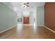 Spacious living room with wood-look tile floors and double doors at 123 Old Spanish Way, Winter Haven, FL 33884