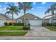 One-story house with a two car garage and lush landscaping at 16716 Rolling Green Dr, Clermont, FL 34714