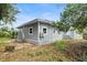 Gray house with a white lattice base, and a partially visible back yard at 1800 4Th Nw St, Winter Haven, FL 33881