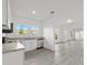 Modern kitchen with white cabinets, granite counters, and stainless steel appliances at 1800 4Th Nw St, Winter Haven, FL 33881