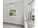 Simple bedroom with window, vinyl flooring, and wall-mounted AC unit at 1800 4Th Nw St, Winter Haven, FL 33881