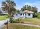 Newly renovated home with gray siding, landscaping, and palm tree at 1800 4Th Nw St, Winter Haven, FL 33881