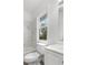 Updated bathroom with marble-look walls and white fixtures at 1800 4Th Nw St, Winter Haven, FL 33881