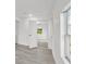 Bright hallway with vinyl flooring and doors to other rooms at 1800 4Th Nw St, Winter Haven, FL 33881