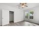 Bright bedroom with hardwood floors, ceiling fan, and large closet at 1800 4Th Nw St, Winter Haven, FL 33881