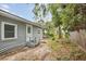 Side view of a gray house with wooden steps leading to the entrance at 1800 4Th Nw St, Winter Haven, FL 33881