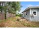 Backyard view with gray house exterior and a wooden fence at 1800 4Th Nw St, Winter Haven, FL 33881