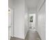 Hallway with light gray vinyl flooring and white doors at 1800 4Th Nw St, Winter Haven, FL 33881