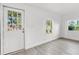 Bright living room with white walls, vinyl flooring, and multiple windows at 1800 4Th Nw St, Winter Haven, FL 33881