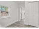 Bedroom with window, vinyl flooring, and a closet at 1800 4Th Nw St, Winter Haven, FL 33881