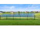 Lakefront backyard with a view of the community and a lush lawn at 193 Stargrass Dr, Auburndale, FL 33823
