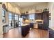 Community kitchen with island, stainless steel appliances, and dark wood cabinets at 193 Stargrass Dr, Auburndale, FL 33823