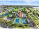 Aerial view of community with pools, tennis courts, and clubhouse at 193 Stargrass Dr, Auburndale, FL 33823