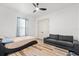 Bright bedroom with a queen bed, couch, and wood-look floors at 193 Stargrass Dr, Auburndale, FL 33823