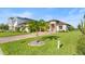 One-story home with a paver driveway and a tropical landscaping at 193 Stargrass Dr, Auburndale, FL 33823