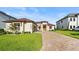 Two-story home with a paver driveway and landscaping at 193 Stargrass Dr, Auburndale, FL 33823