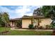 Cute ranch home with red shutters and lush landscaping at 1937 Rifle Range Rd, Winter Haven, FL 33880