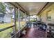 Relaxing screened porch with patio furniture, perfect for outdoor dining at 1937 Rifle Range Rd, Winter Haven, FL 33880