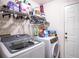 Laundry room with washer, dryer, and storage shelves at 1937 Rifle Range Rd, Winter Haven, FL 33880