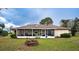 Back exterior view of the house with a screened porch and fire pit at 1937 Rifle Range Rd, Winter Haven, FL 33880