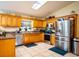 Well-equipped kitchen with wood cabinets and stainless steel appliances at 1937 Rifle Range Rd, Winter Haven, FL 33880