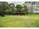 Rustic carport with space for multiple vehicles and equipment at 1957 Rifle Range Rd, Winter Haven, FL 33880