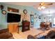 Bright living room with a fireplace and large TV at 1957 Rifle Range Rd, Winter Haven, FL 33880