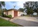 Single car garage with a reddish-brown door and satellite dish at 1957 Rifle Range Rd, Winter Haven, FL 33880