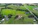 Aerial view showing a house on a large lot with surrounding farmland at 1957 Rifle Range Rd, Winter Haven, FL 33880