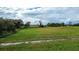 Aerial view of a large grassy field with a dirt road at 1957 Rifle Range Rd, Winter Haven, FL 33880