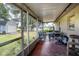 Spacious screened porch with seating area and views of the yard at 1957 Rifle Range Rd, Winter Haven, FL 33880