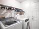 Bright laundry room with washer, dryer, and ample hanging space at 1957 Rifle Range Rd, Winter Haven, FL 33880