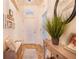 Bright and airy entryway with a bench and decorative plants at 230 Grouper Ct, Poinciana, FL 34759