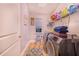 Laundry room with washer, dryer, and overhead shelving at 230 Grouper Ct, Poinciana, FL 34759