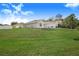 Large front yard with manicured lawn and a two-car garage at 230 Grouper Ct, Poinciana, FL 34759