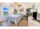 Bright bedroom with a queen bed, large window, and built-in shelving at 230 Grouper Ct, Poinciana, FL 34759
